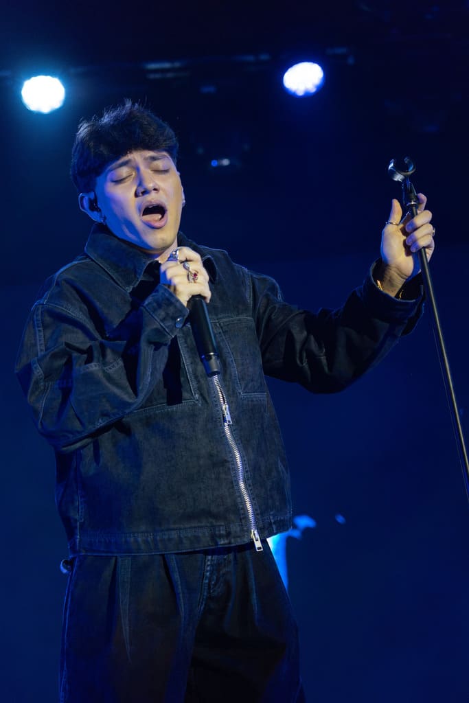 JJ sings on stage: an artist in the moment of performance, expressing emotion through music